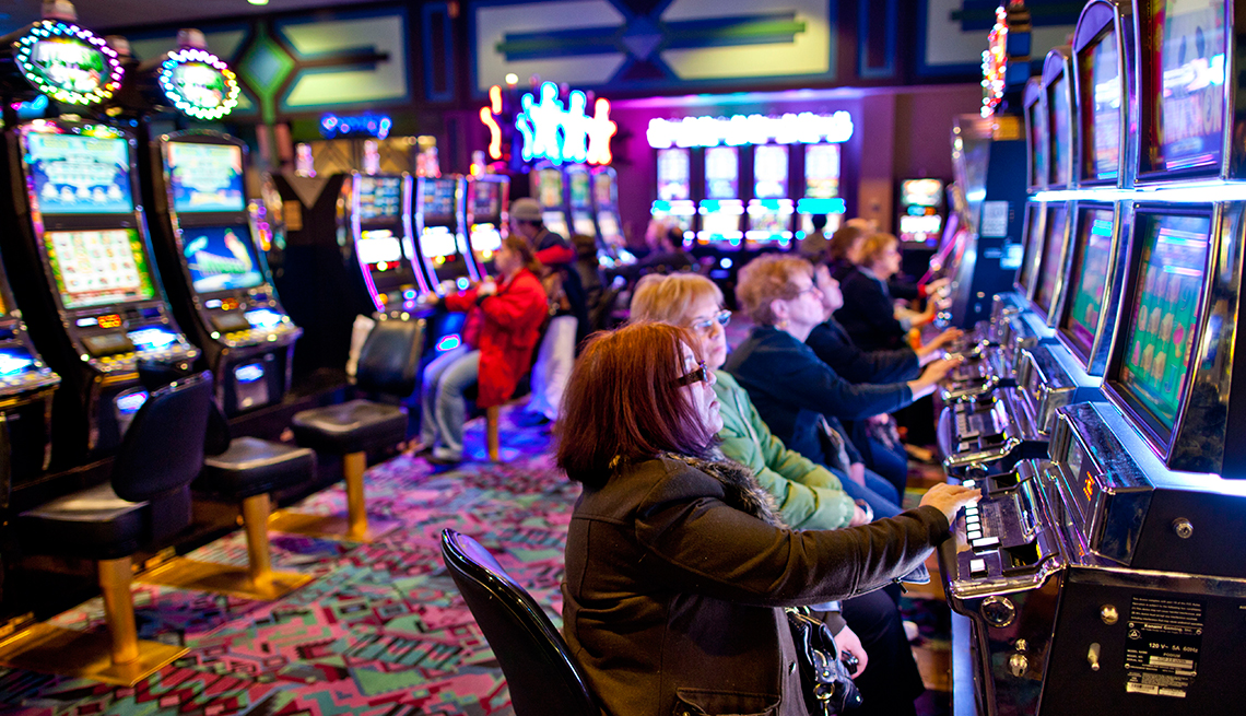 Old people playing with casino machines